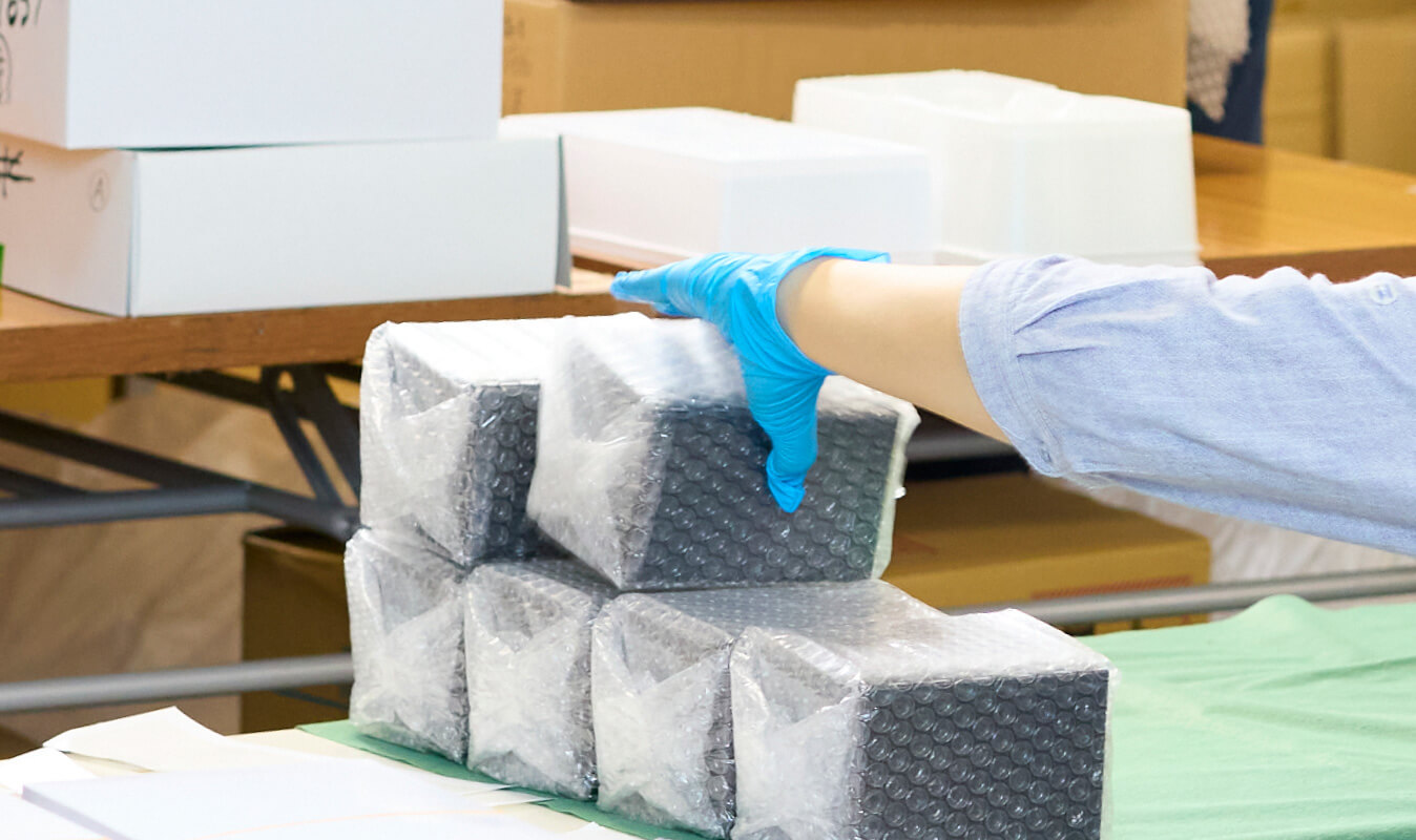 写真：丁寧に梱包作業をする